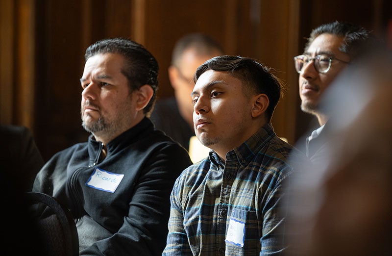 Three students attending the HSI Visioning Forum in Kerckhoff Hall.